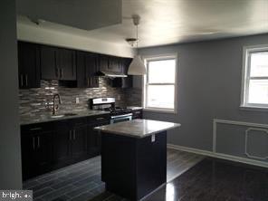 a kitchen with sink cabinets and window