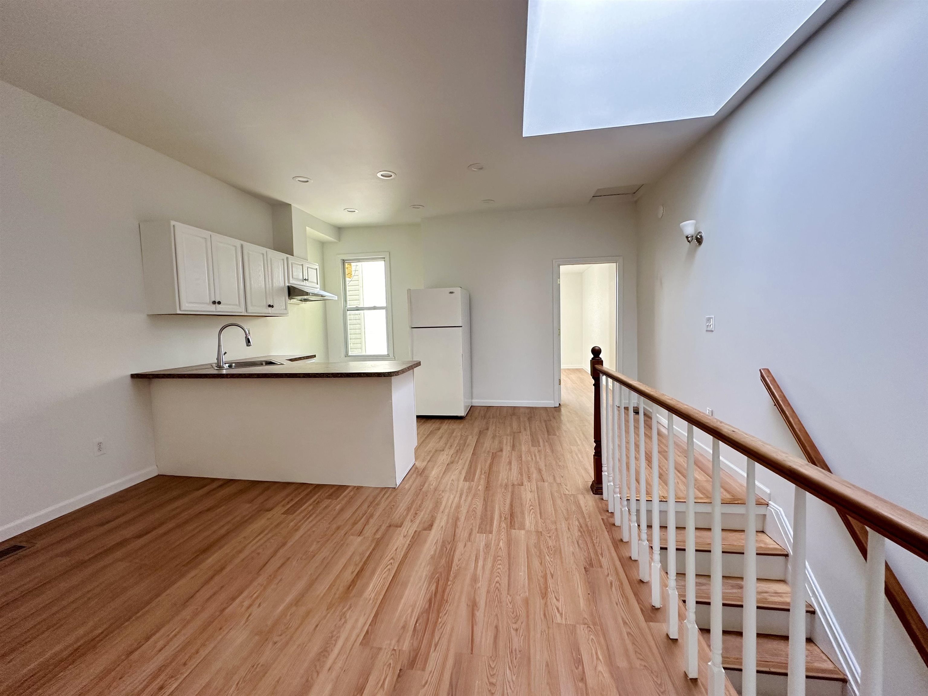 a view of a kitchen from wooden floor