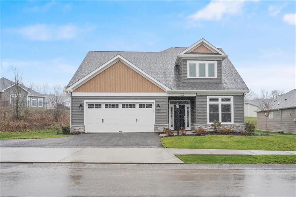 a front view of a house with a yard and garage