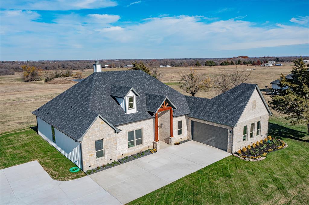 an aerial view of a house with a yard