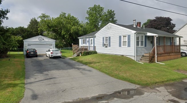 a front view of a house with a yard and garage