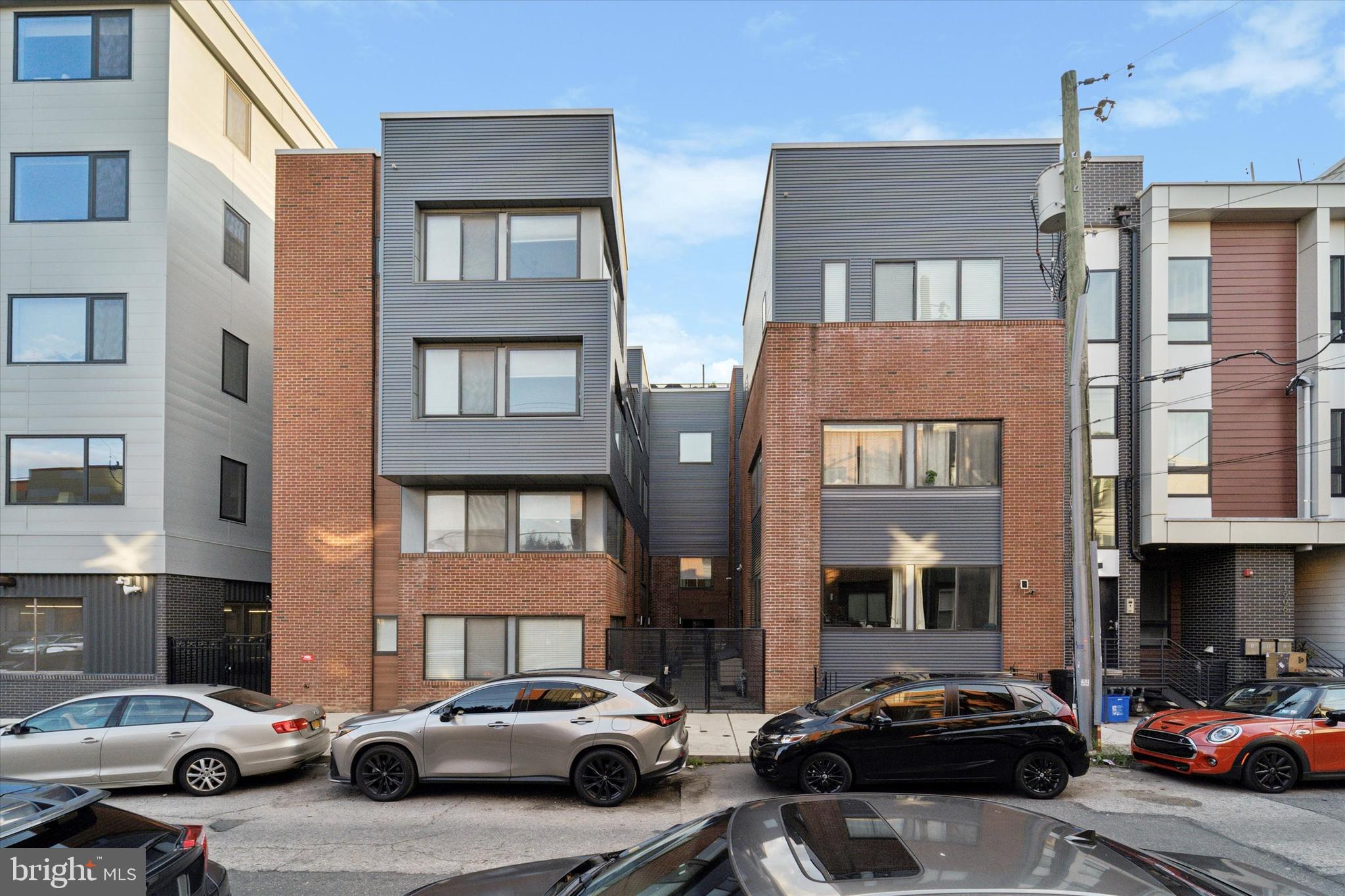 a couple of cars parked in front of a building