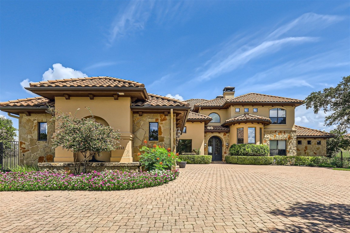 a front view of a house with garden