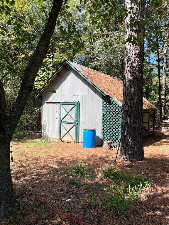 a view of a house with a yard and tree