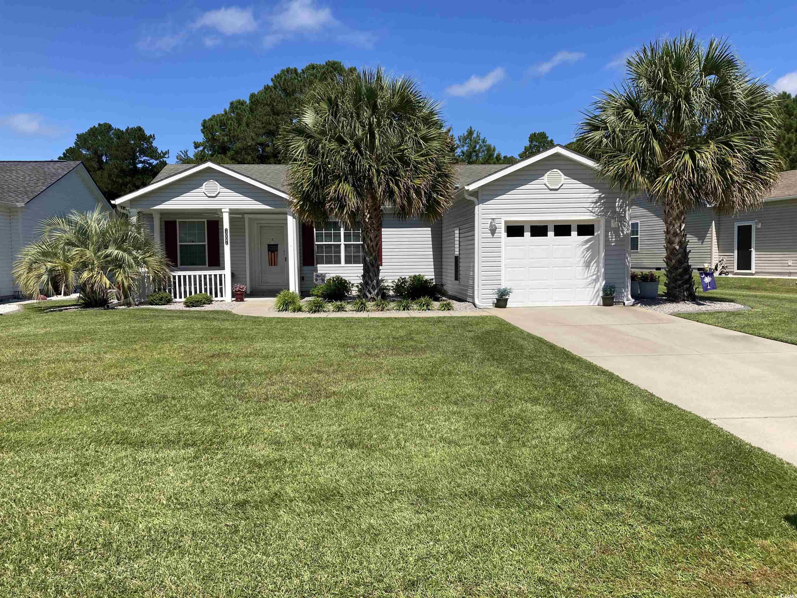 Ranch-style house featuring a front lawn, a porch,