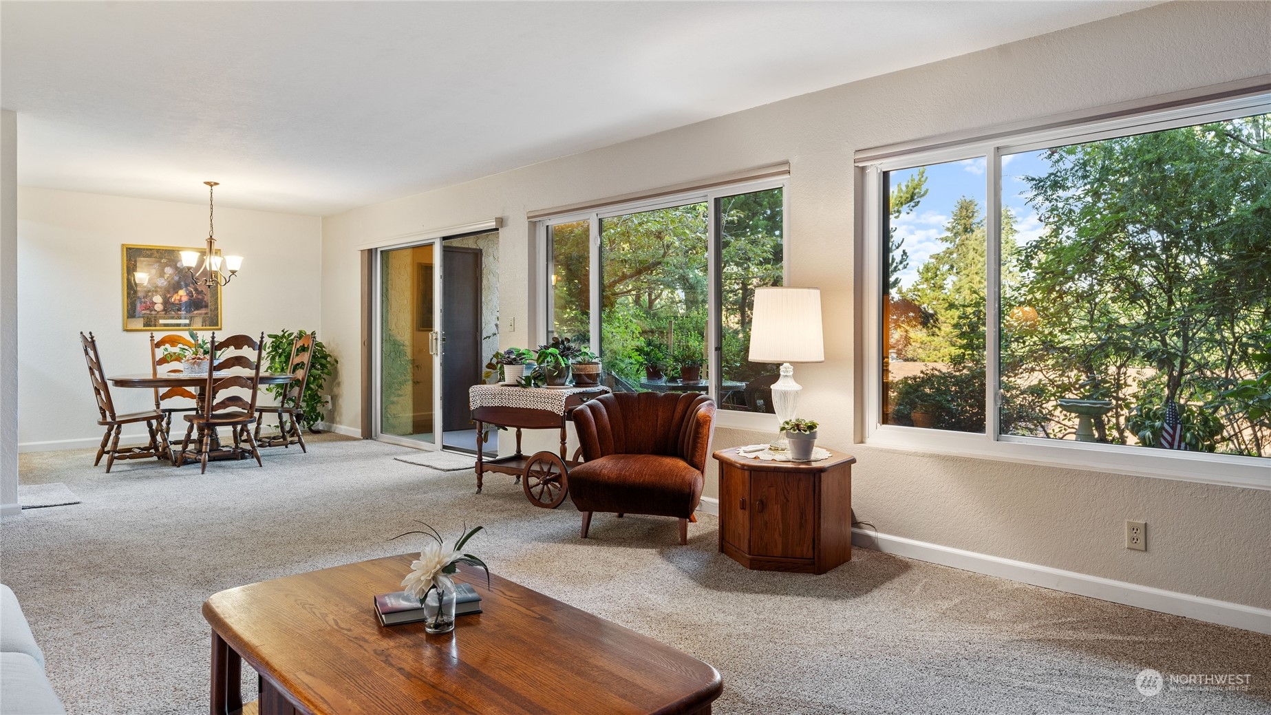 a living room with furniture and large windows