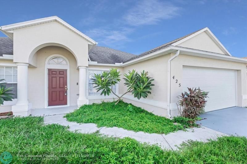 a front view of a house with garden