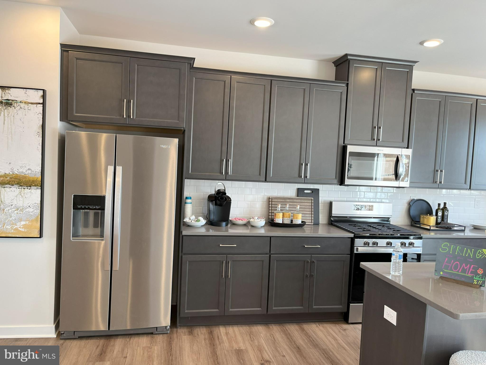 a kitchen with stainless steel appliances granite countertop a refrigerator stove and sink