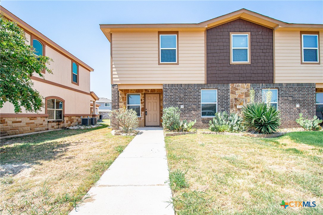 a front view of a house with a yard