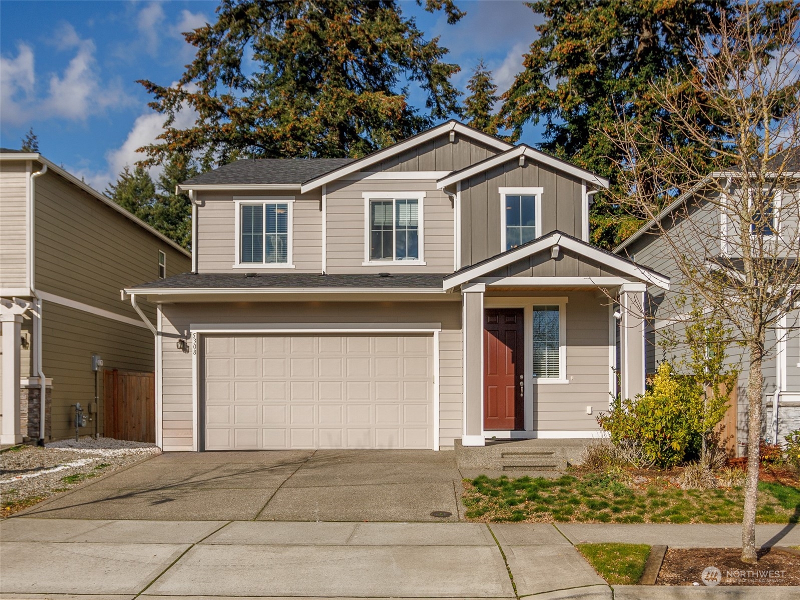 a front view of a house with a yard and garage