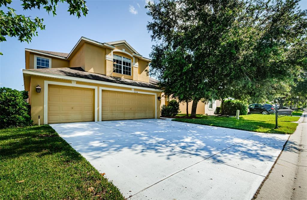 a front view of a house with a yard and garage