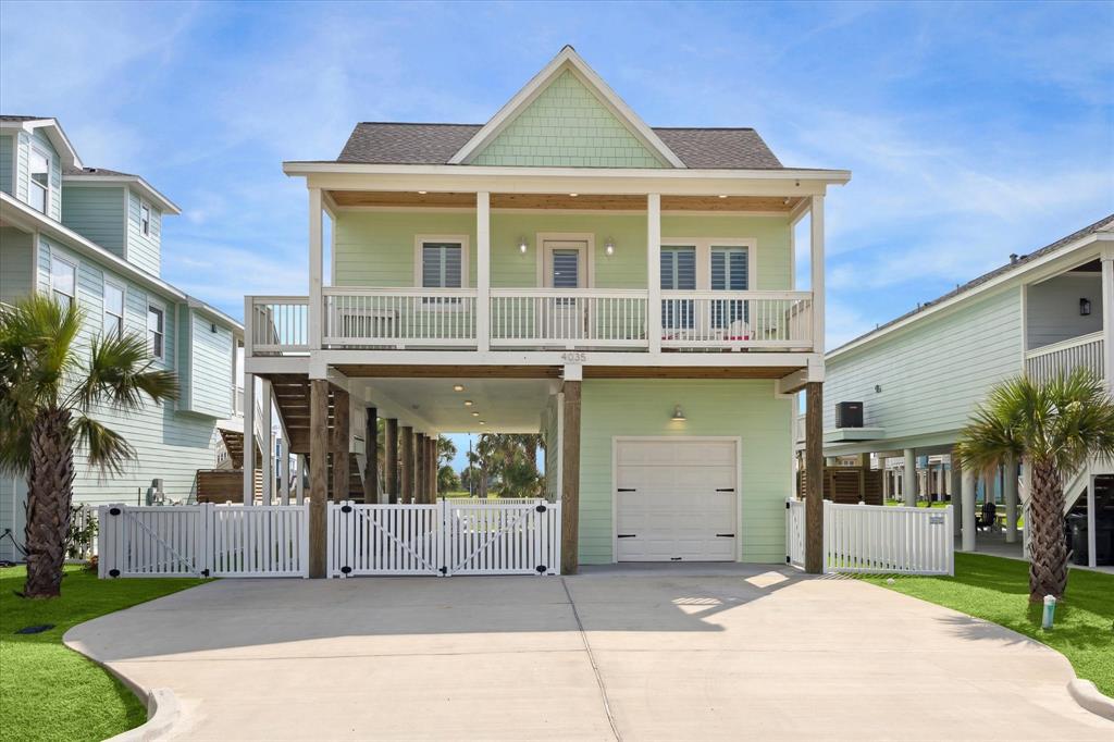 a front view of a house with a garden and garage