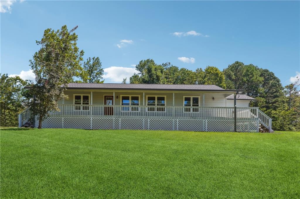 a front view of house with yard and green space