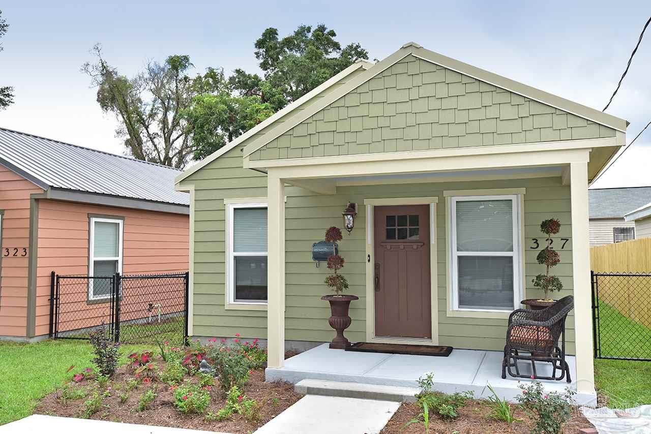 a front view of a house with garden