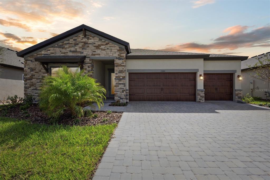 a front view of a house with a yard and garage