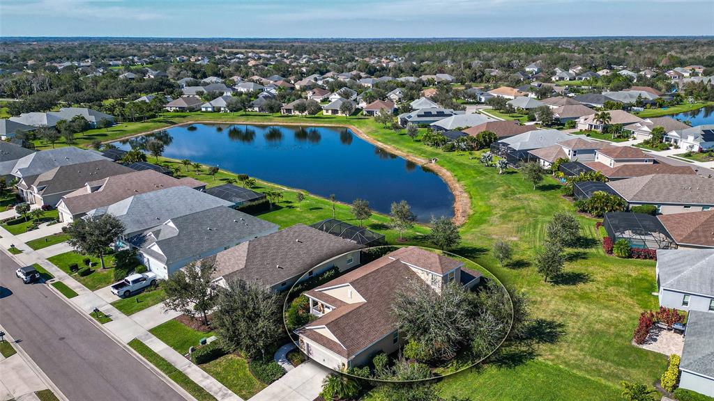 an aerial view of residential houses with outdoor space and river