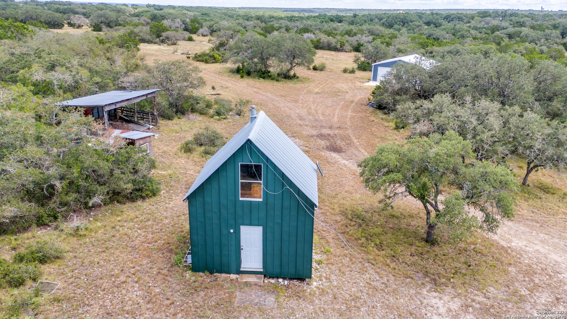 an aerial view of a house with a yard