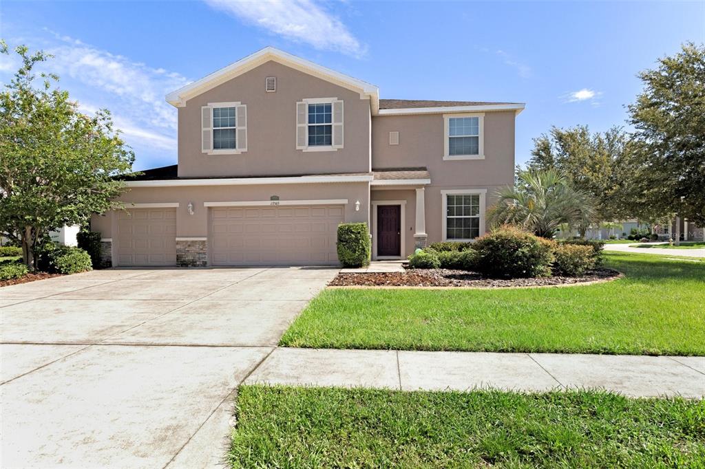 a front view of a house with a yard and garage