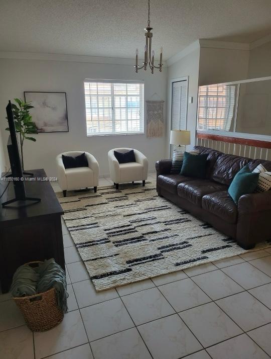 a living room with furniture a chandelier and a window