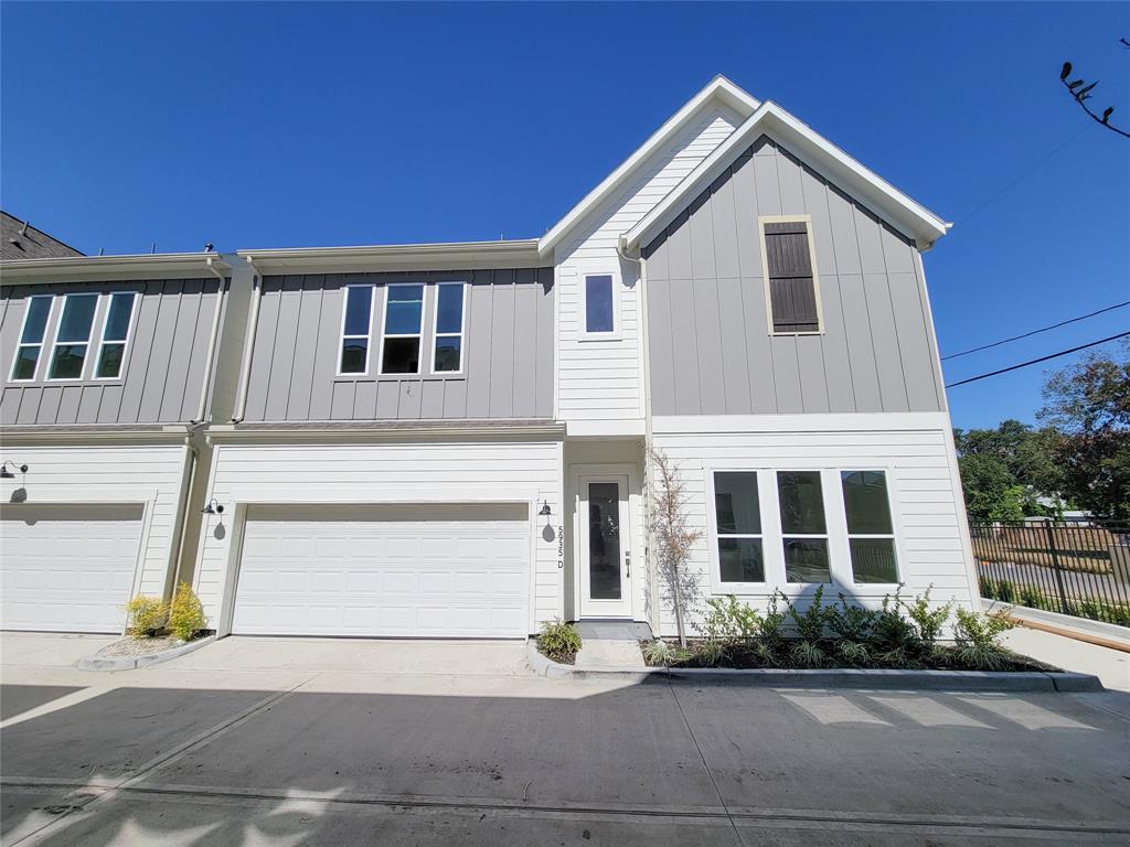 a front view of a house with a garden and parking space