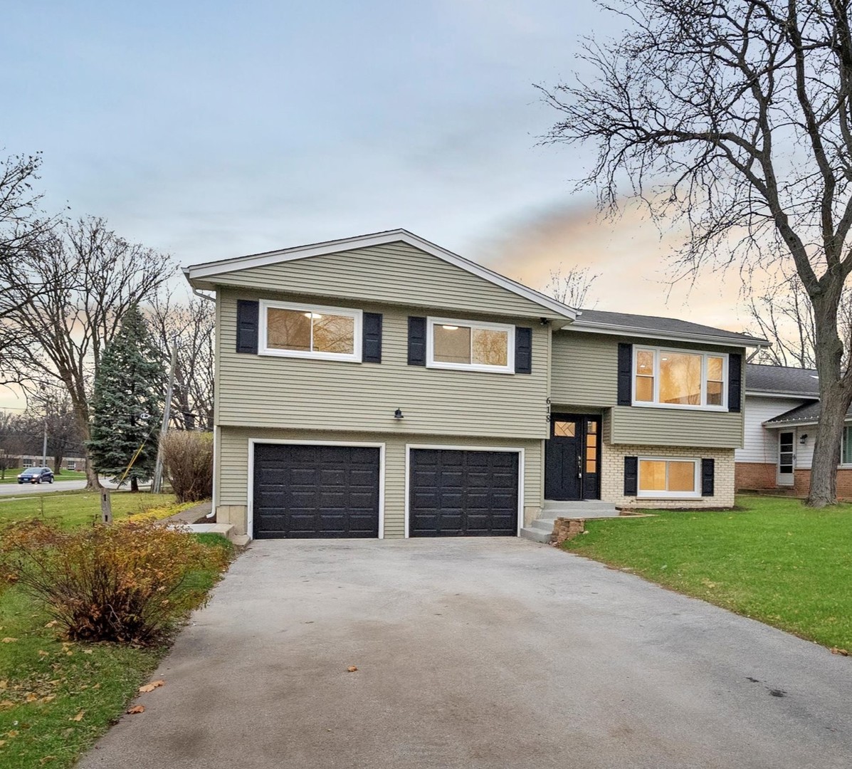 a front view of a house with a yard and garage