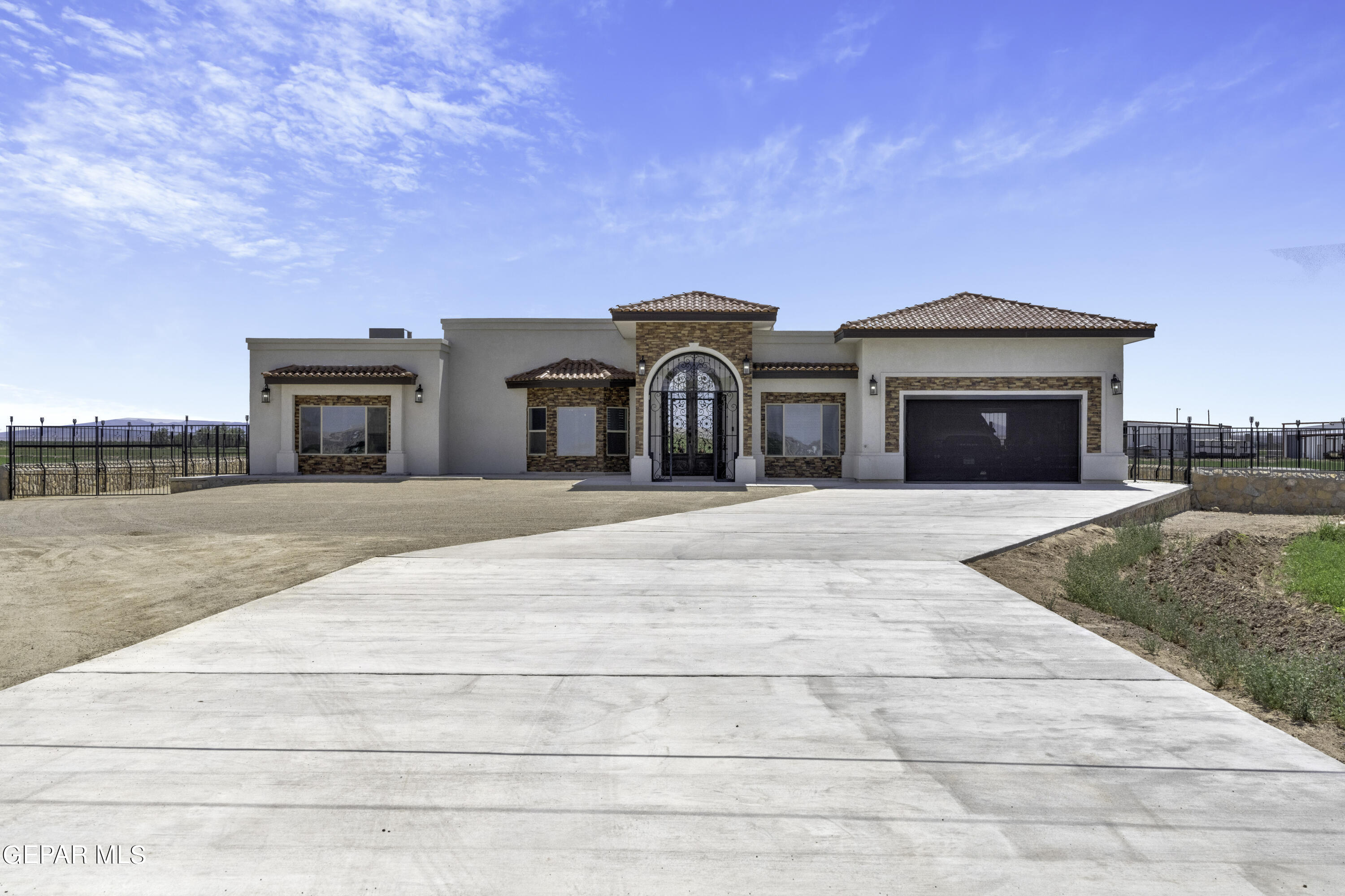 a front view of a house with a garden