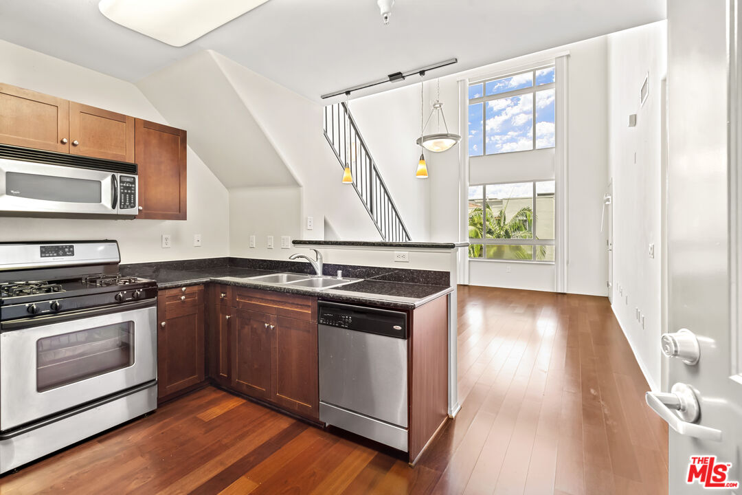 a kitchen with stainless steel appliances granite countertop a stove and a sink