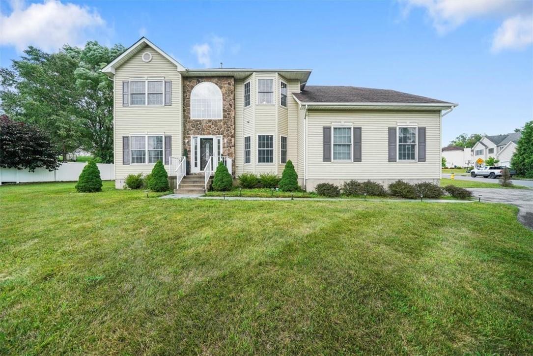 a front view of house with yard and green space