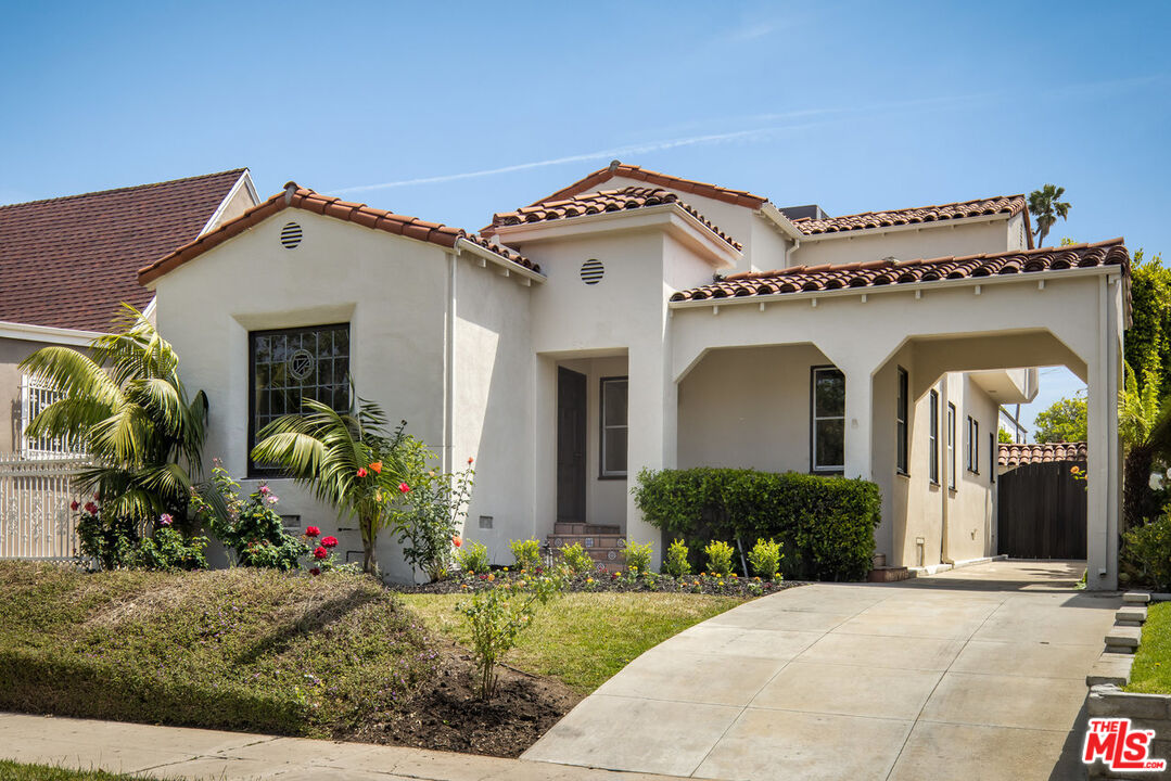 front view of a house with potted plants