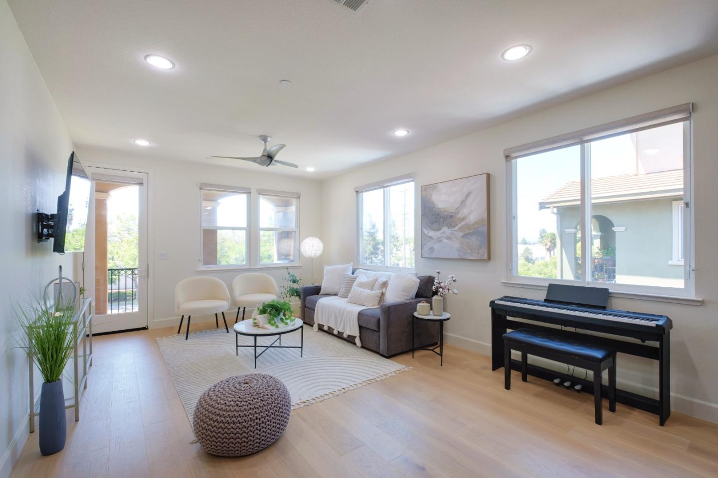 a living room with furniture a table and a large window