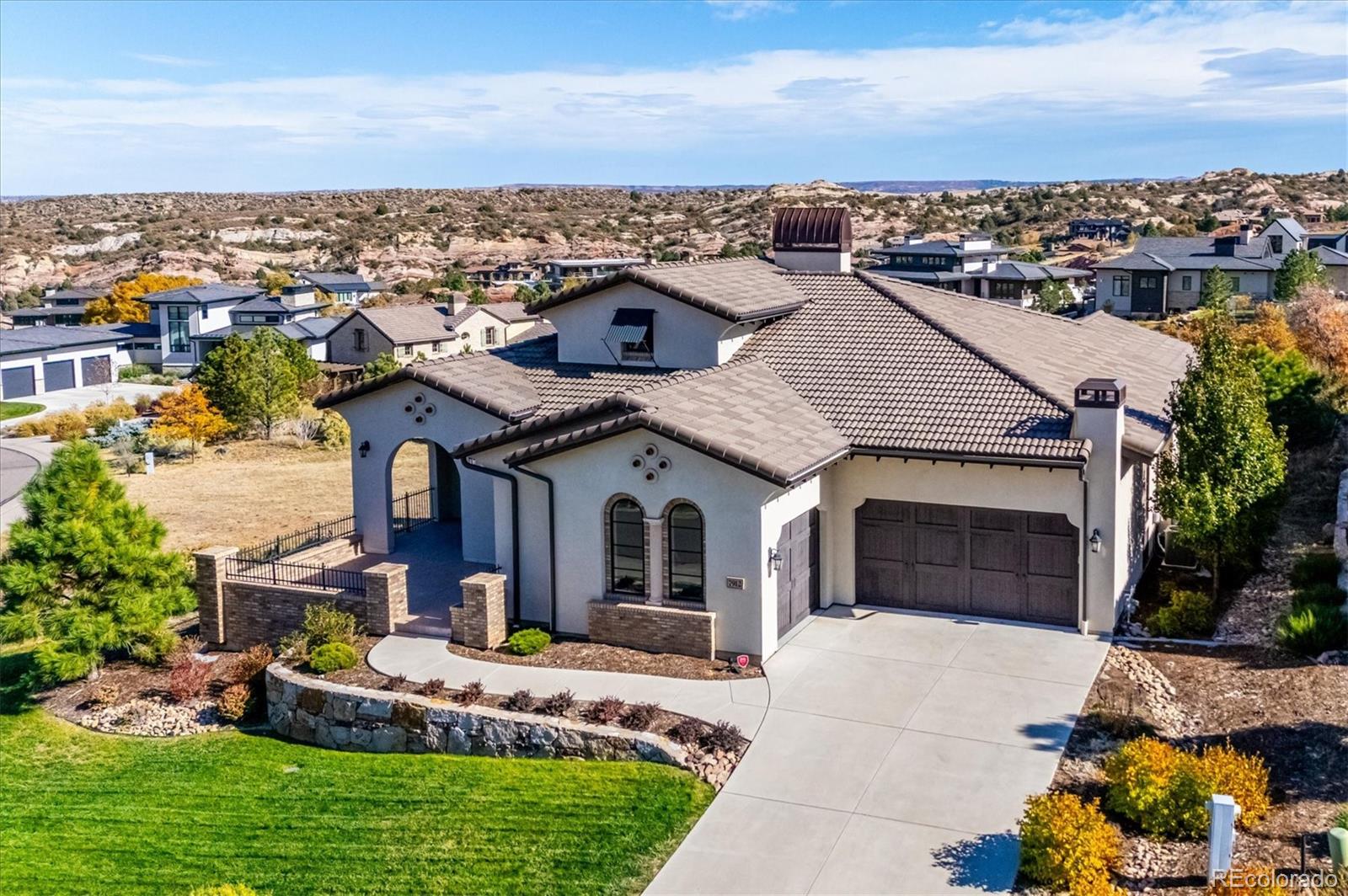 a aerial view of a house with a yard and balcony