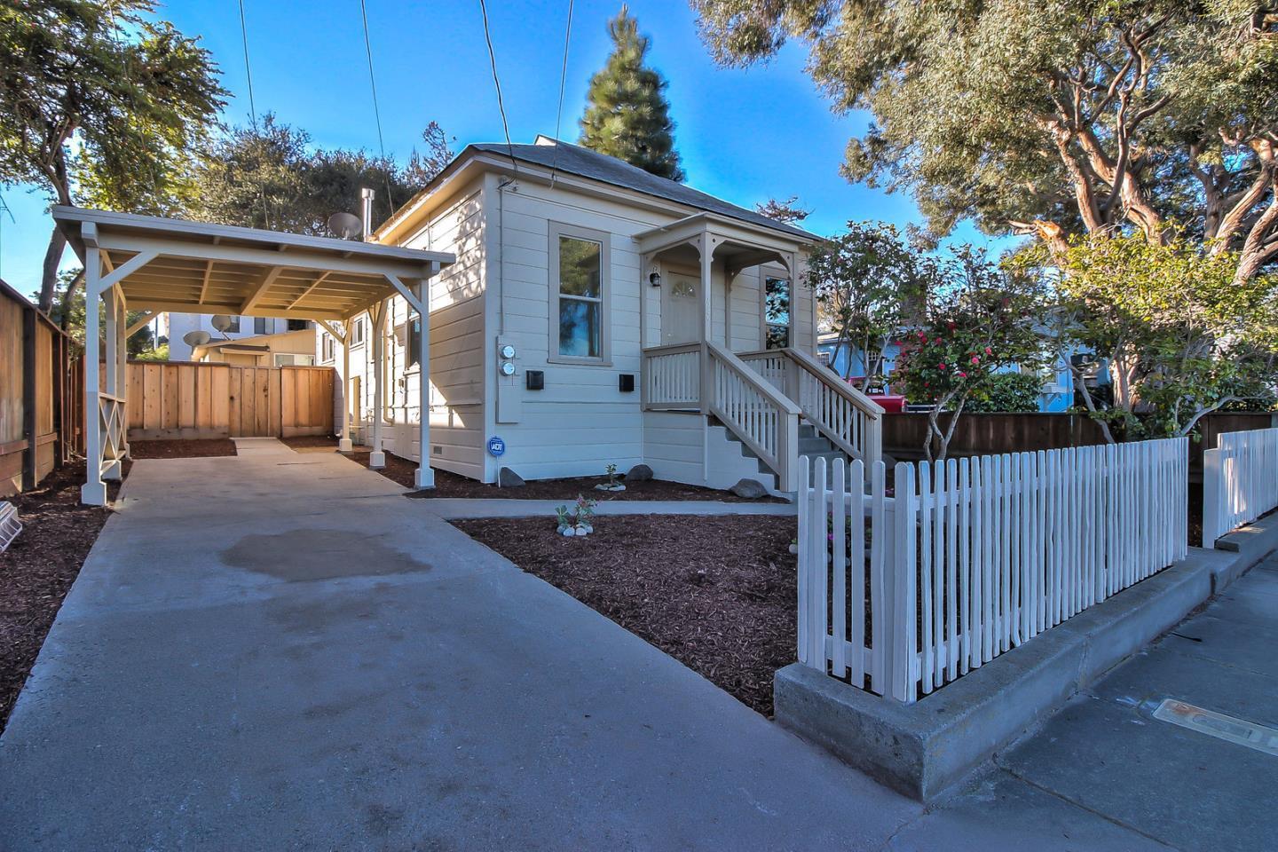 a view of a house with wooden fence