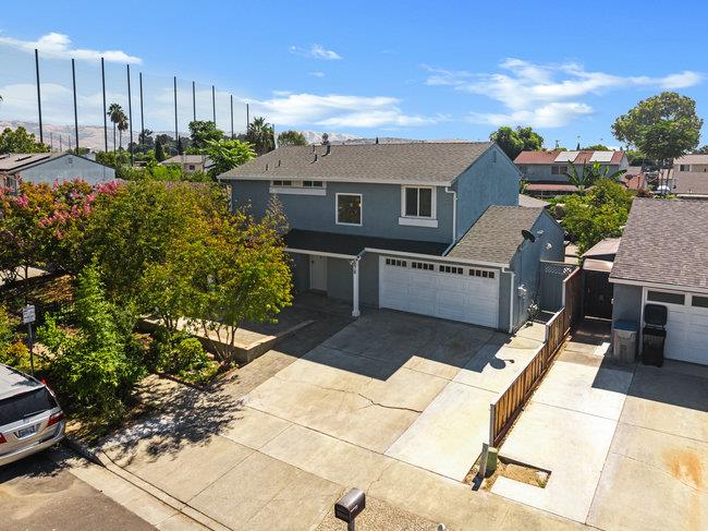 a view of a house with a backyard