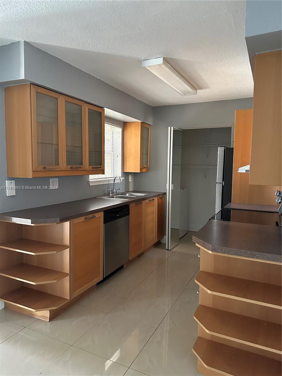 a kitchen with granite countertop a sink and a stove