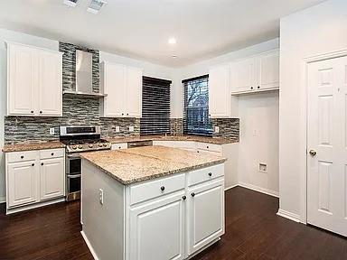 a kitchen with stainless steel appliances granite countertop a stove sink and cabinets