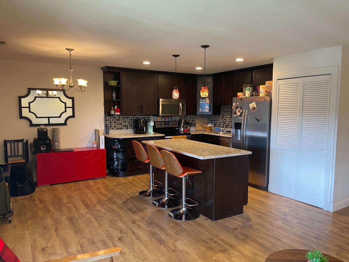 a kitchen with a sink cabinets and wooden floor