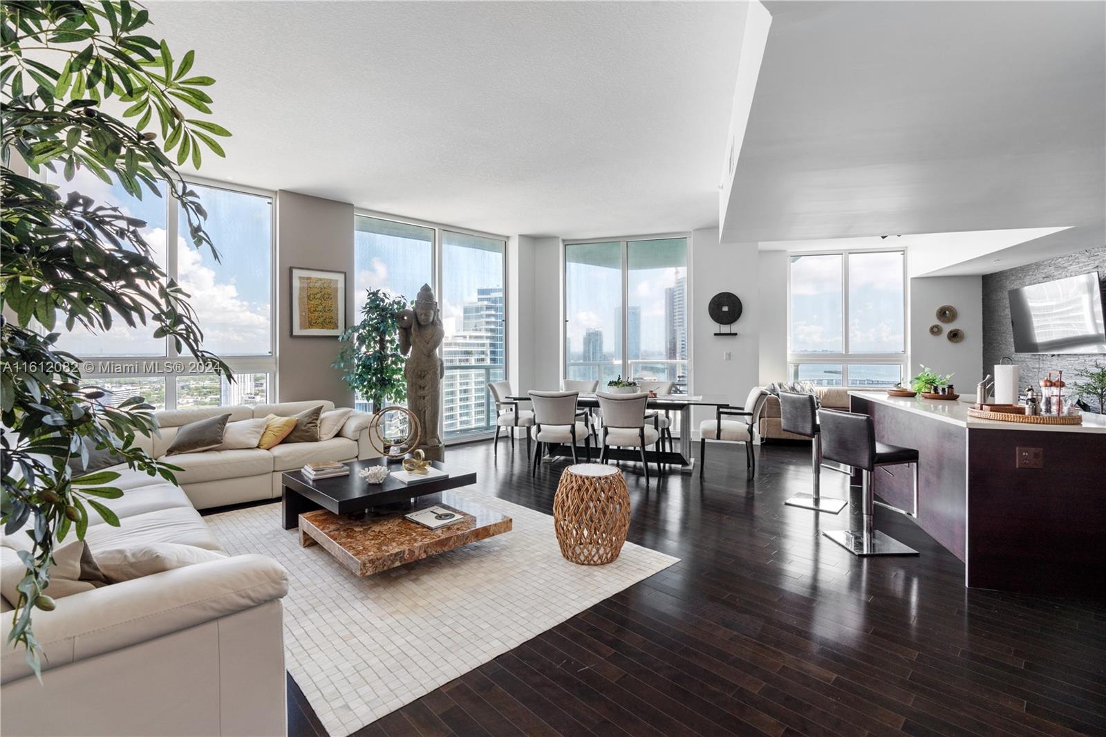 a living room with furniture wooden floor and a large window