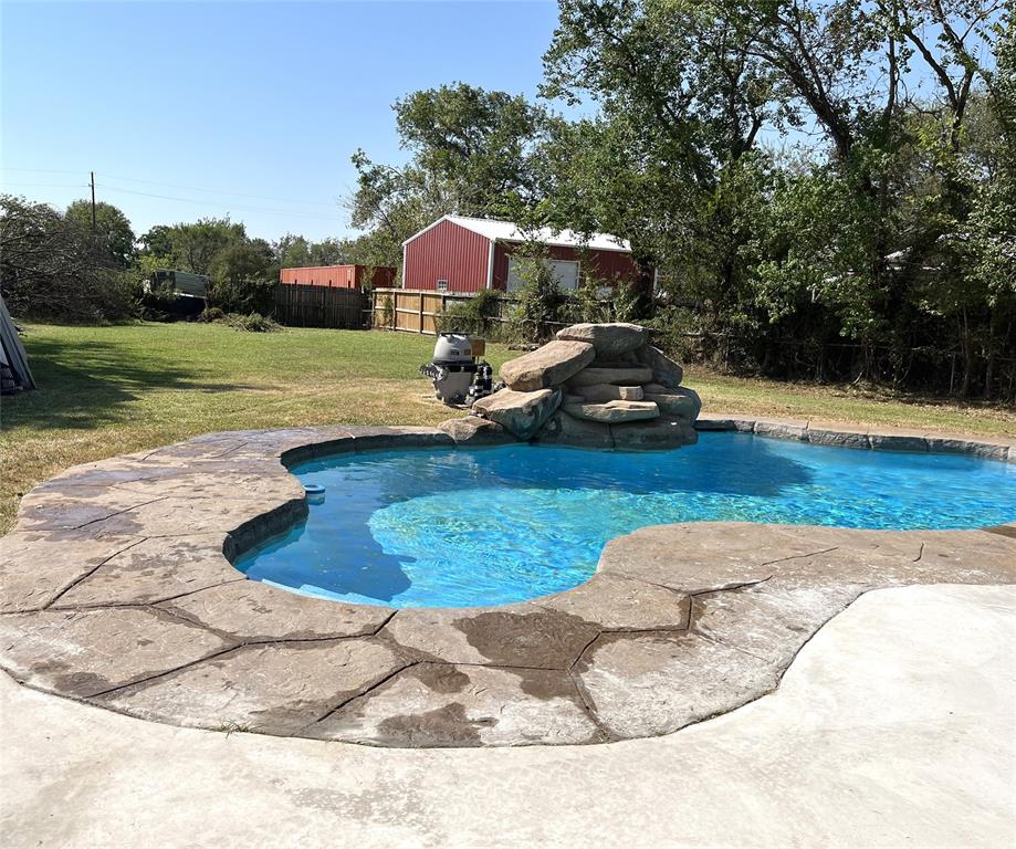 a view of a backyard with lawn chairs and wooden floor