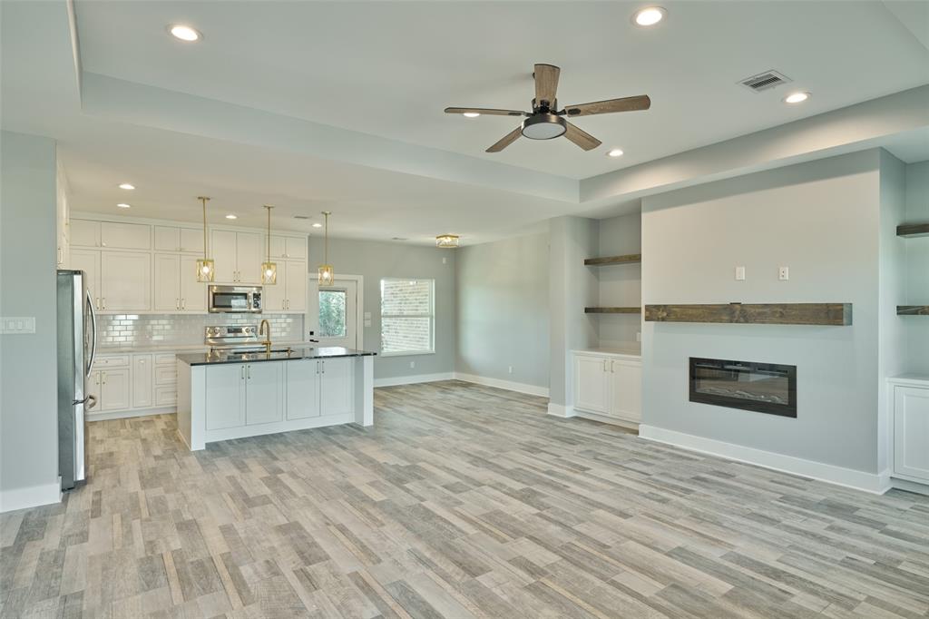 a large kitchen with kitchen island a sink stainless steel appliances and cabinets