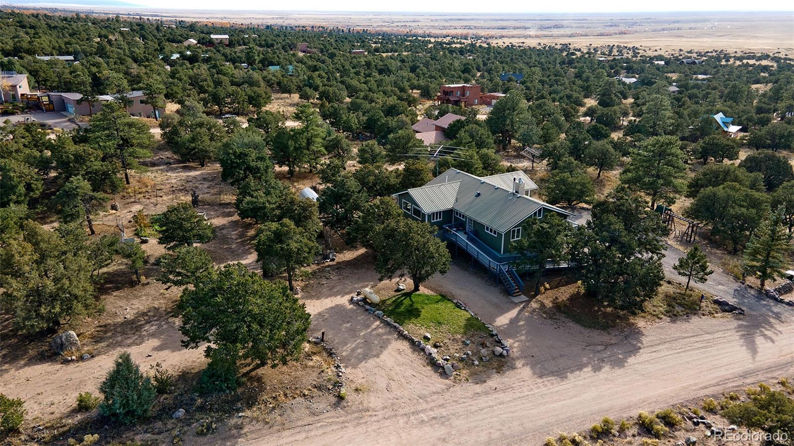 an aerial view of a house with a yard