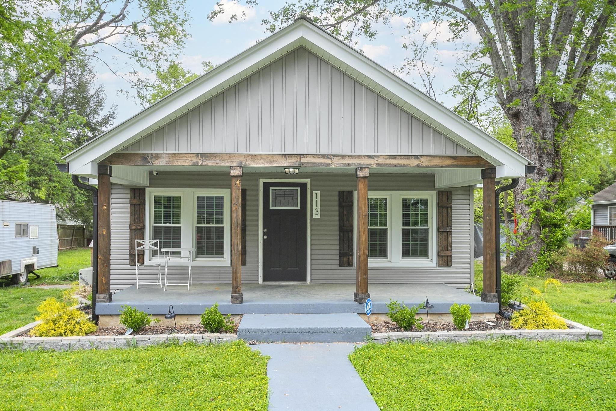 a front view of a house with a yard and porch