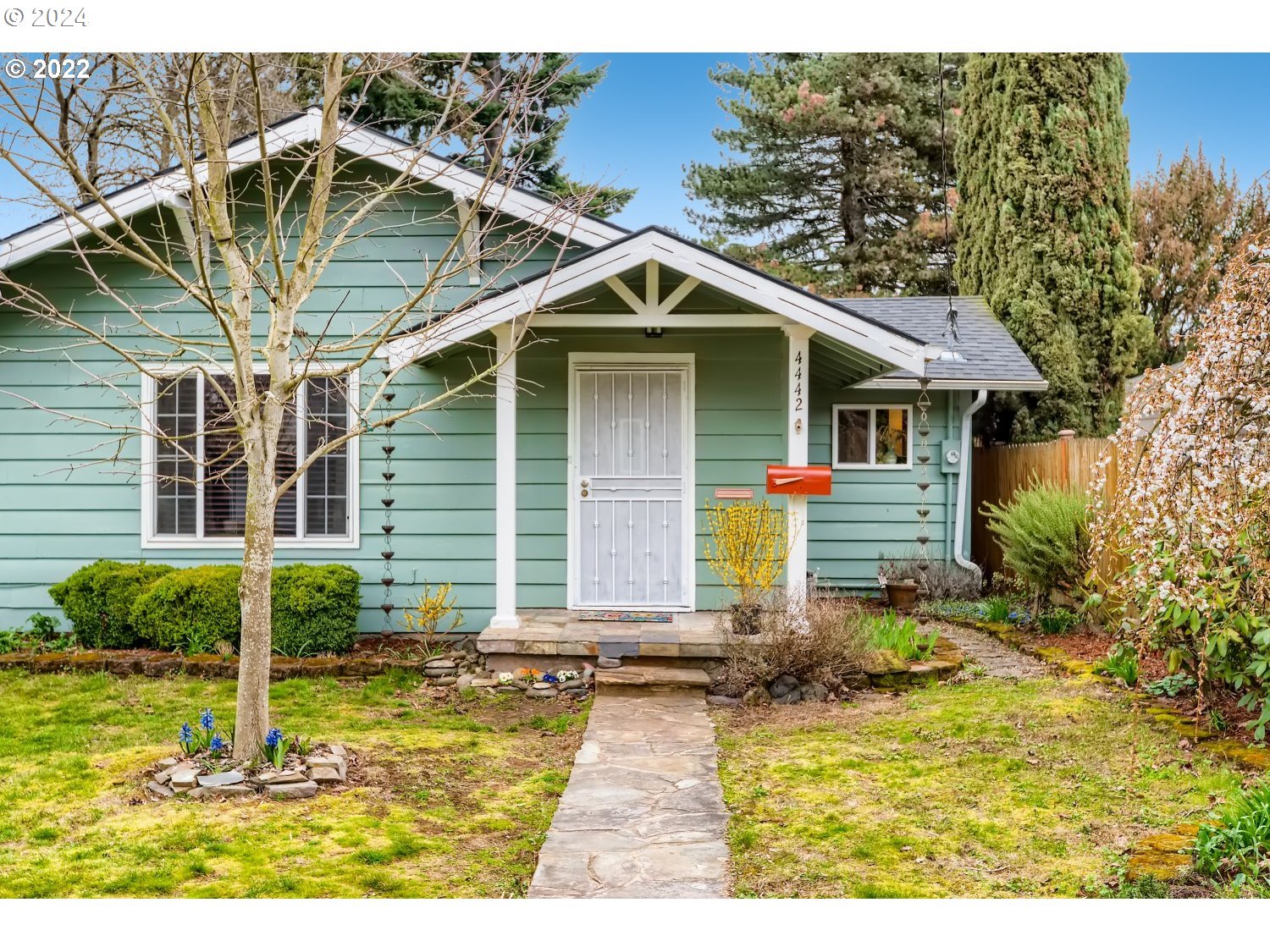 a front view of house with yard and green space