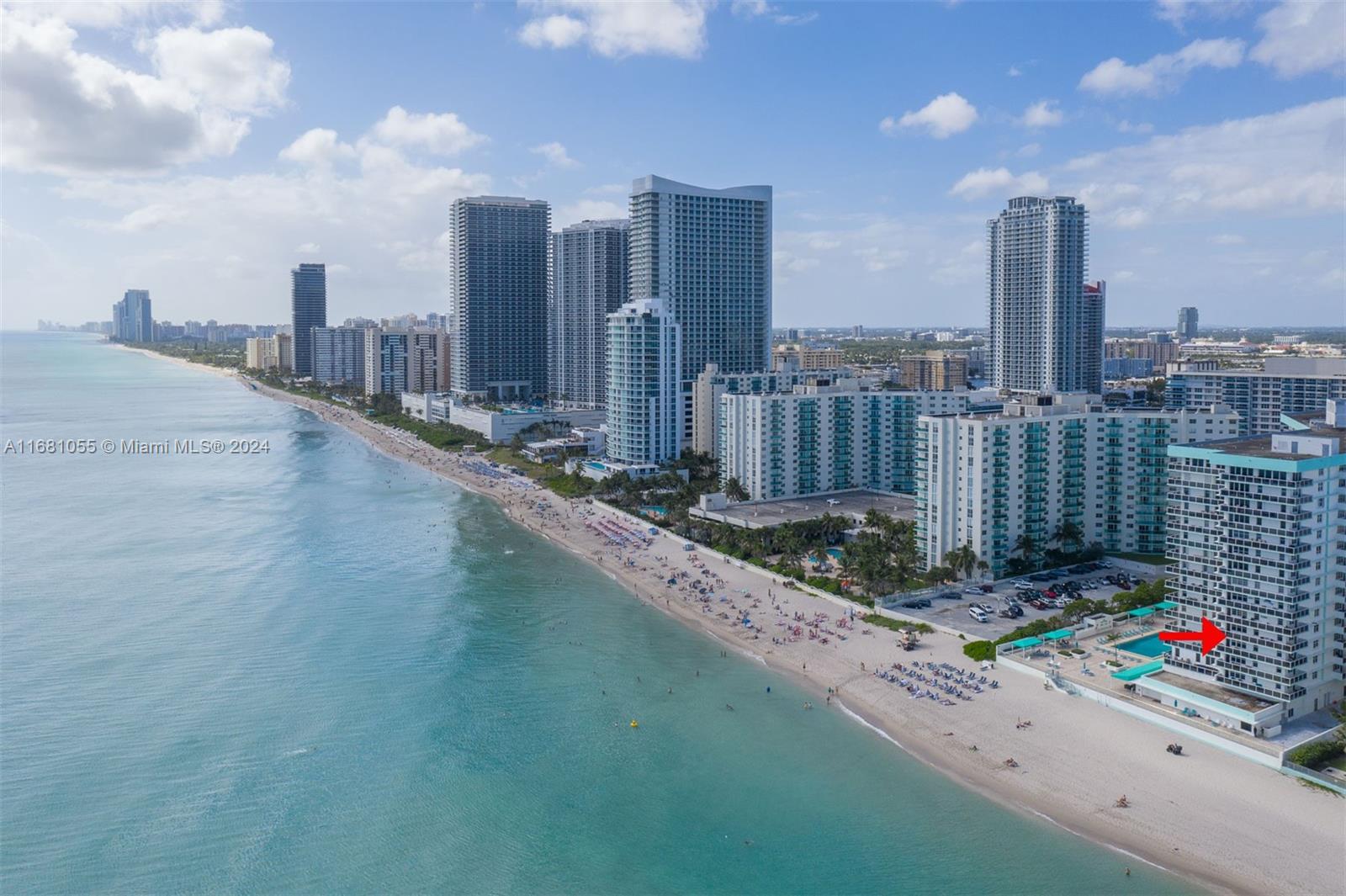 a view of a city with tall buildings and a bench