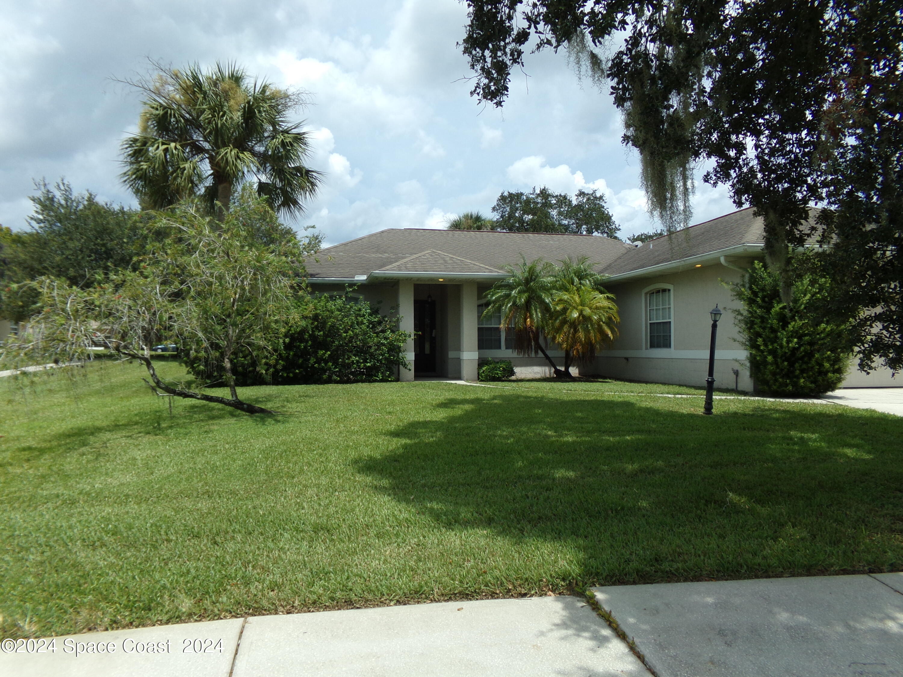 a front view of a house with a garden