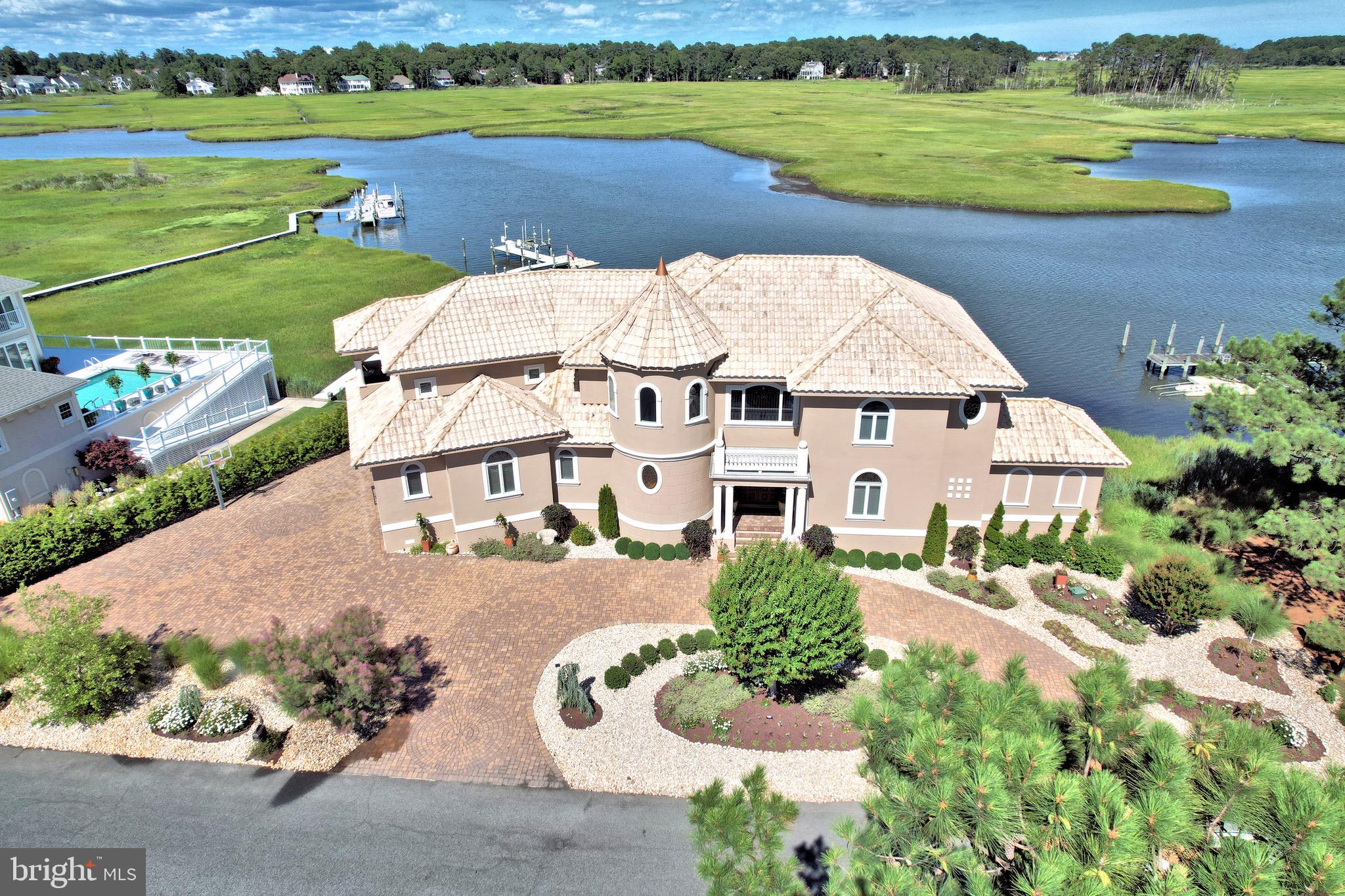 an aerial view of a house with garden space and lake view