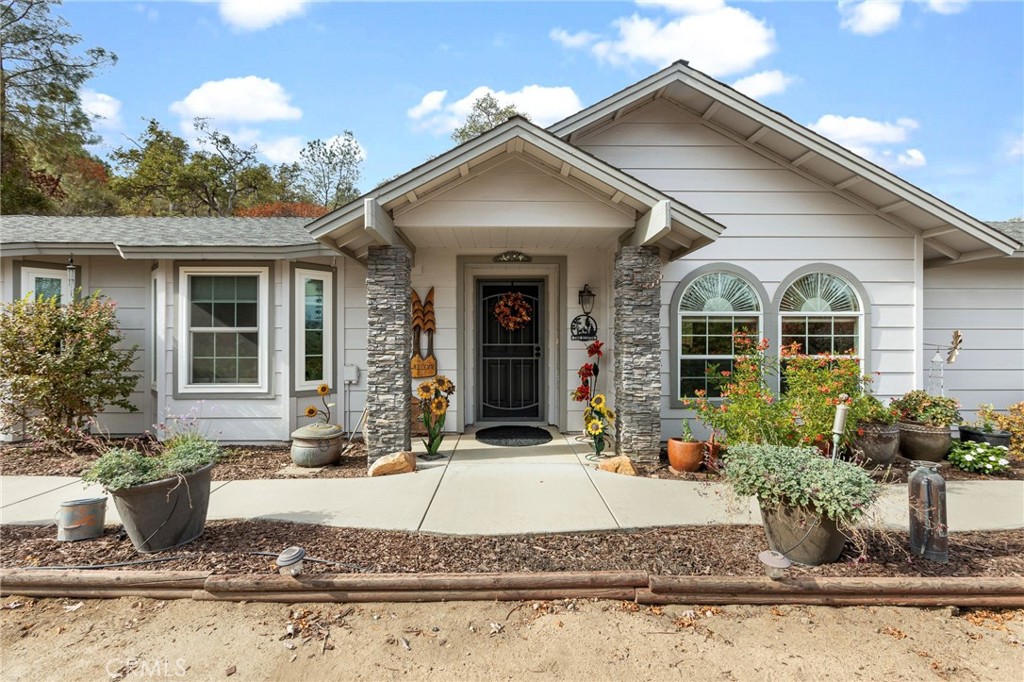 a front view of a house with garden