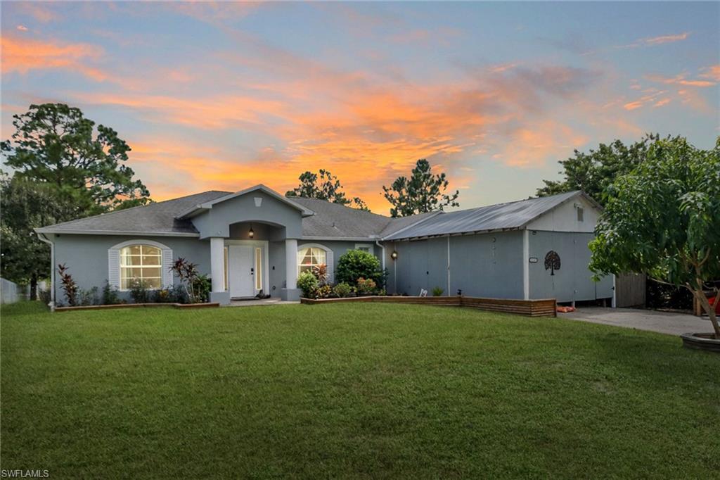 a big house with a big yard and large trees