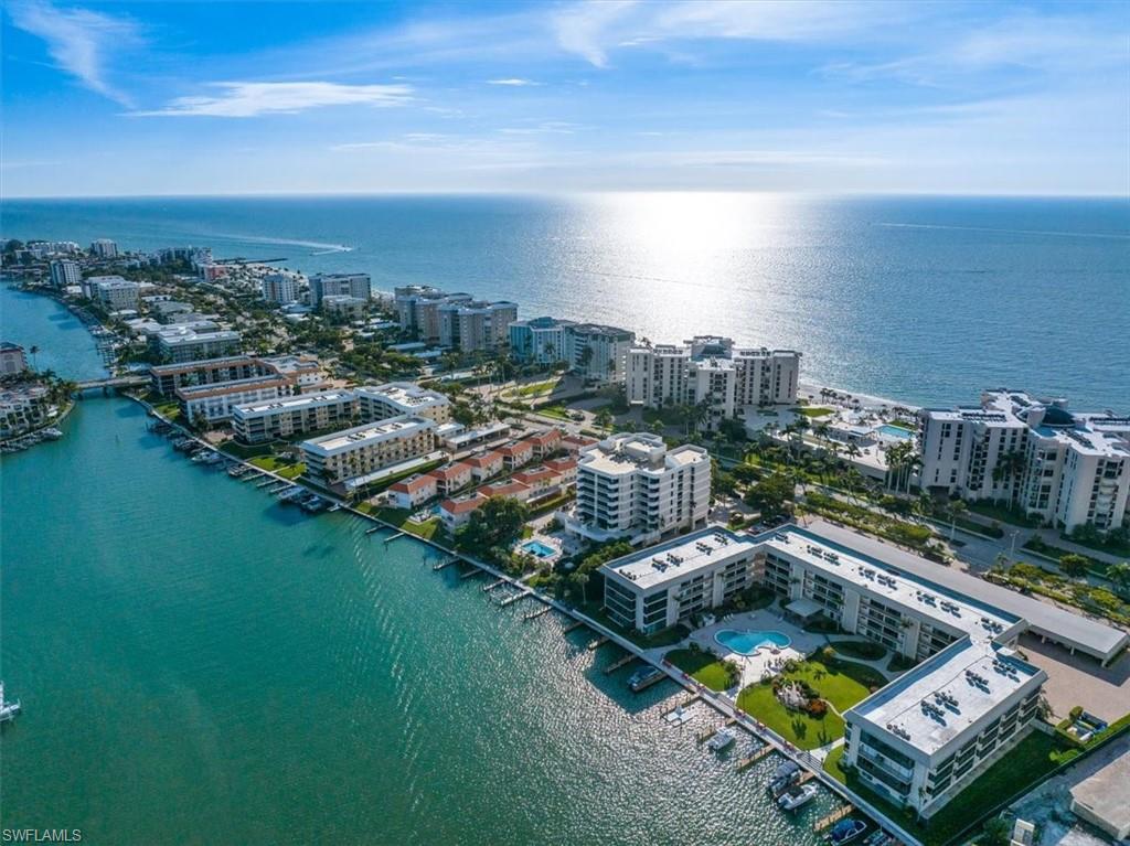 Birds eye view of property with a water view