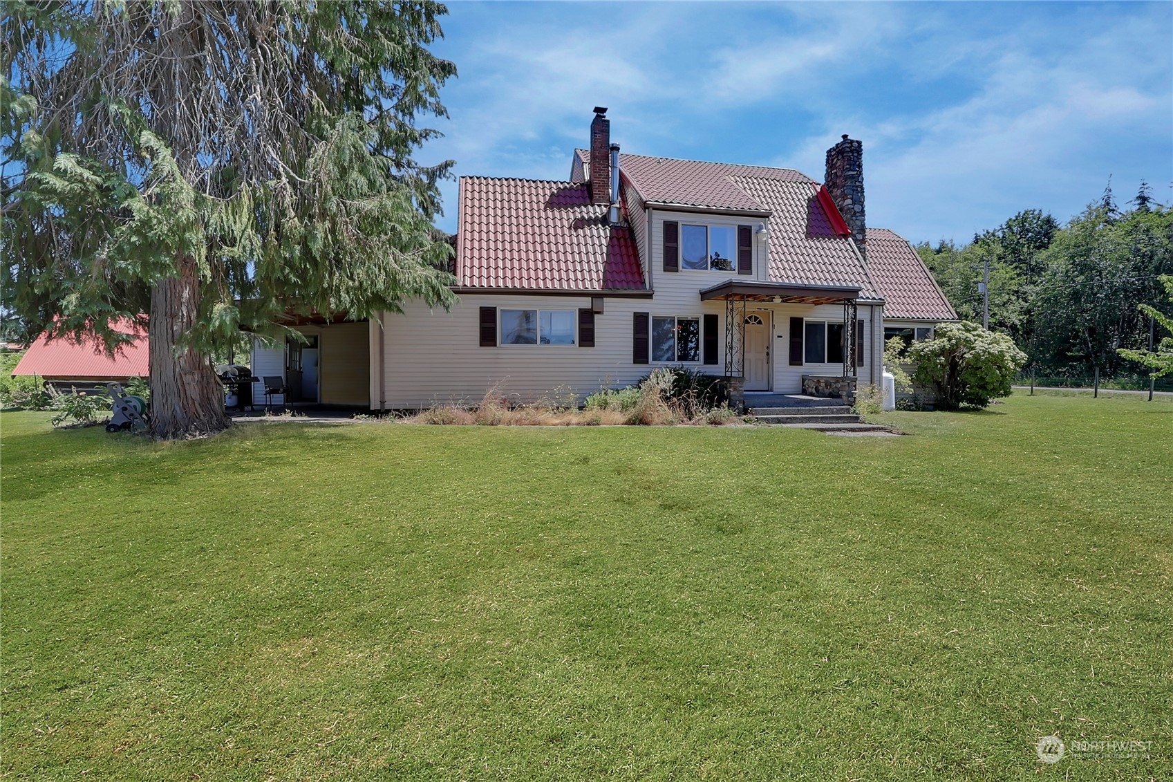 a front view of house with yard and trees