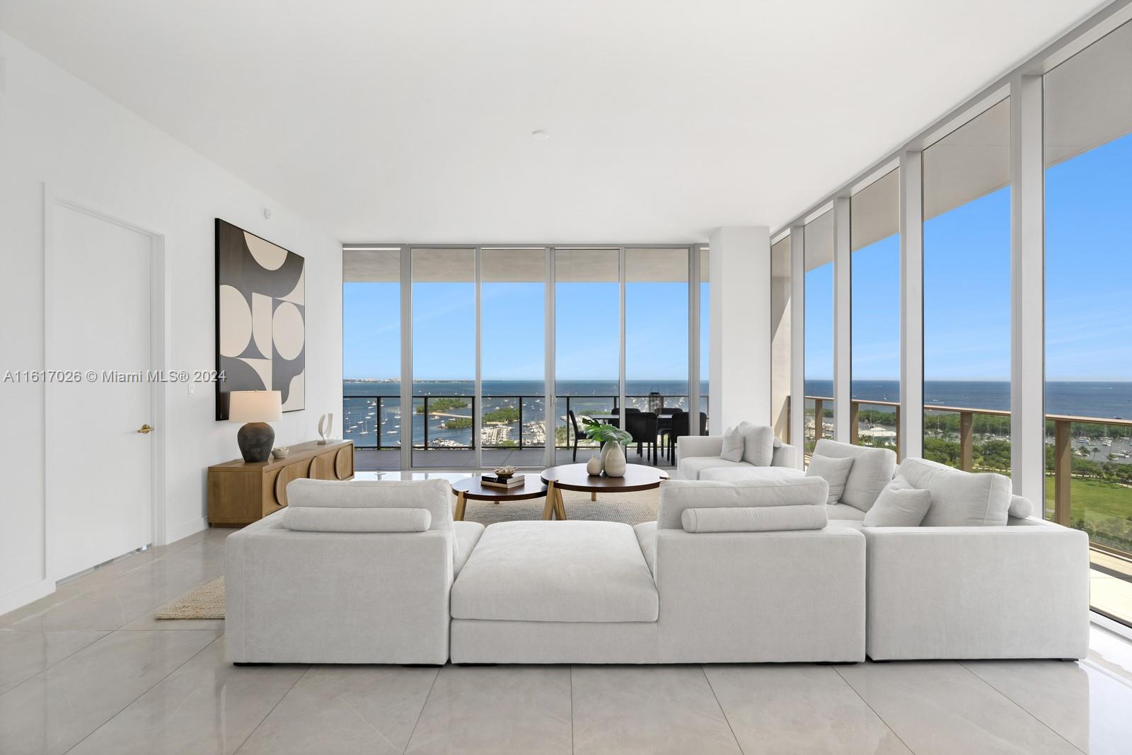 a living room with furniture and large windows